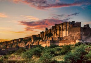 Stunning view of Mehrangarh Fort during a vibrant sunset in Jodhpur, India.